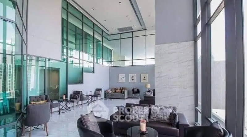Luxurious modern living room with high ceilings and elegant furnishings in a contemporary apartment.