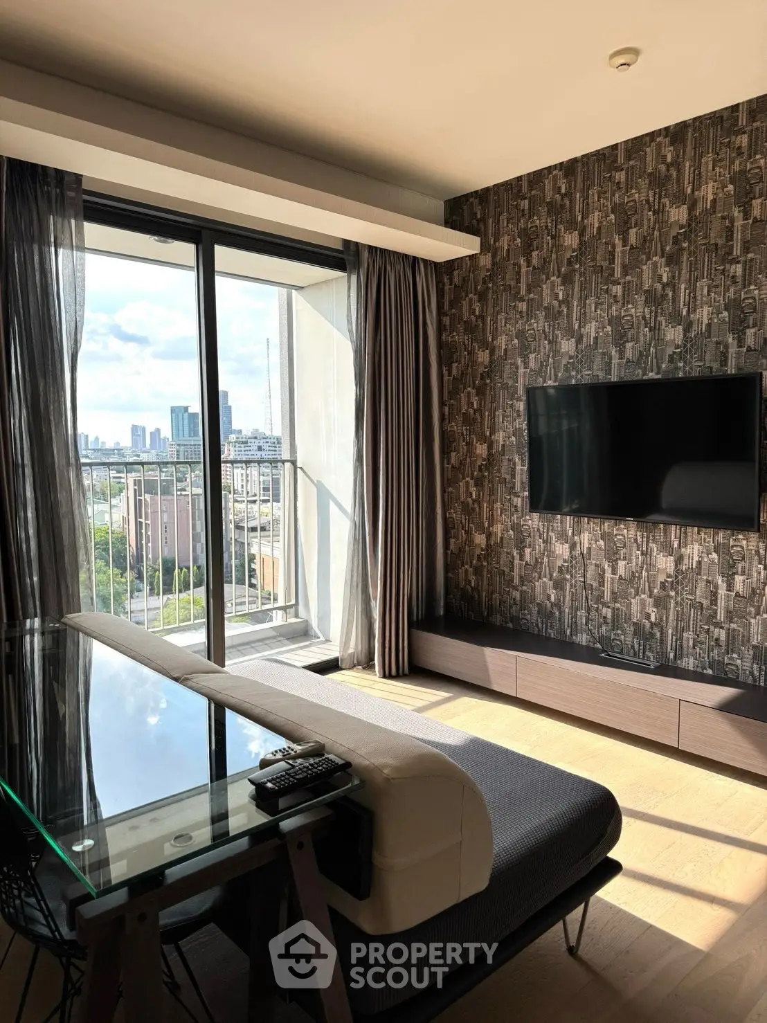 Modern living room with city view, stylish decor, and large window for natural light.