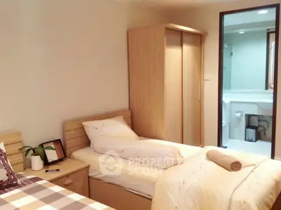 Cozy bedroom with twin beds and ensuite bathroom in modern apartment