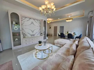 Luxurious living room with elegant chandelier and plush seating
