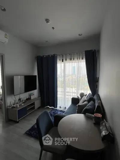 Modern living room with stylish furniture and large window view