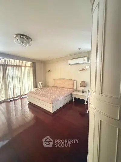 Spacious bedroom with elegant decor and natural light