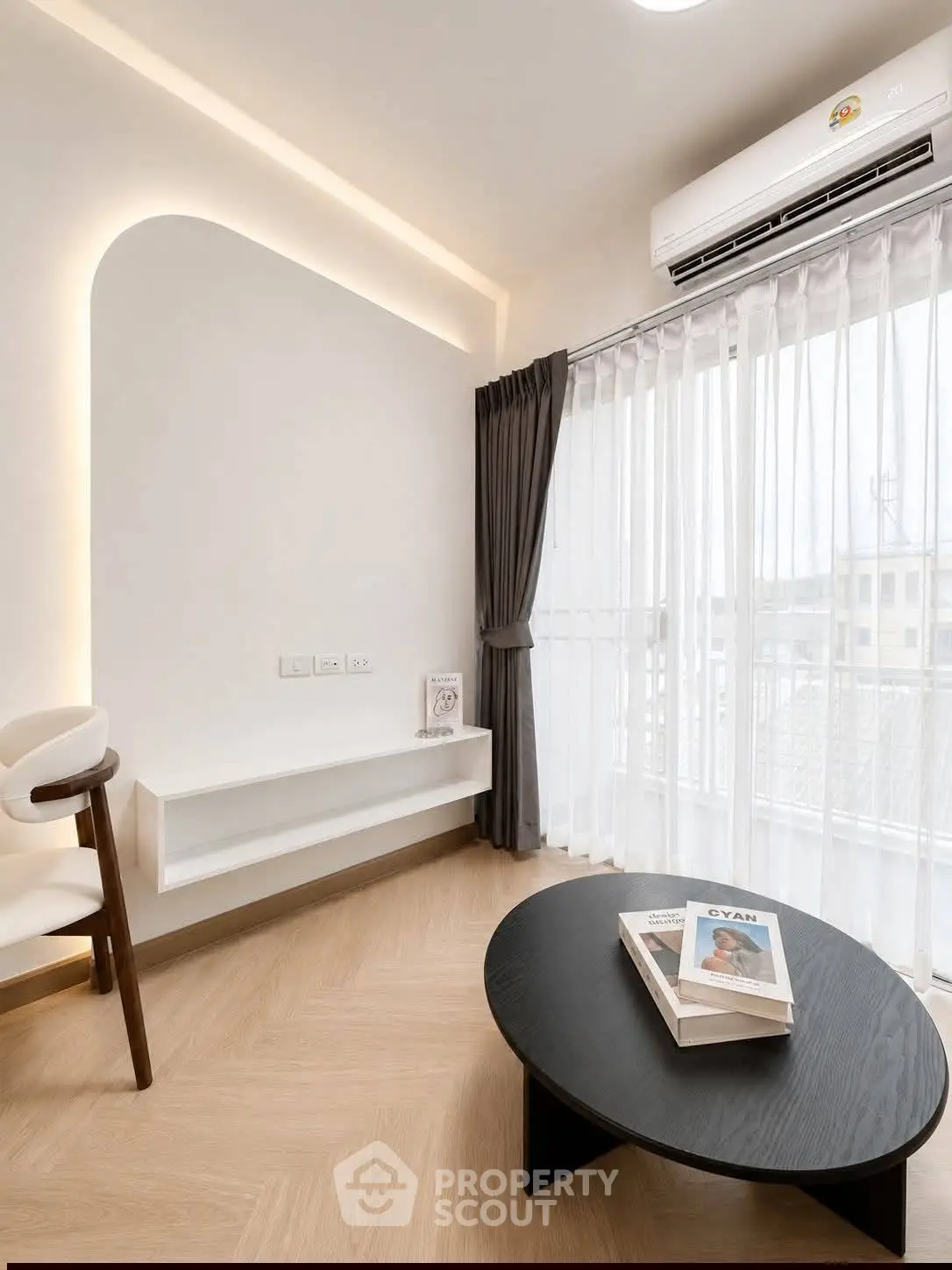 Modern living room with elegant decor, featuring a sleek black coffee table and stylish seating, perfect for relaxation.