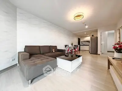 Modern living room with stylish furniture and open kitchen layout