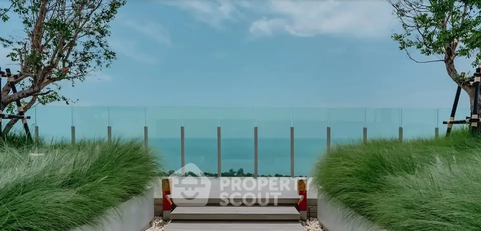 Stunning rooftop terrace with ocean view and lush greenery, perfect for relaxation and entertainment.