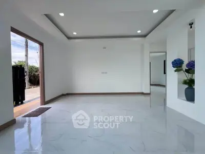 Spacious modern living room with marble flooring and recessed lighting, perfect for elegant living.