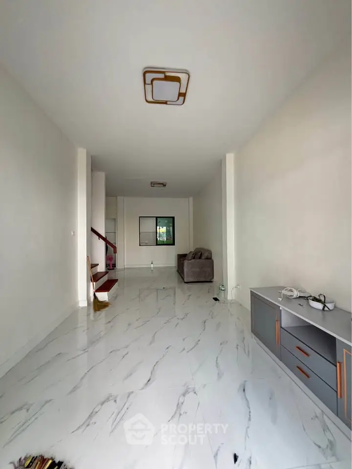Spacious modern living room with sleek marble flooring and minimalist decor
