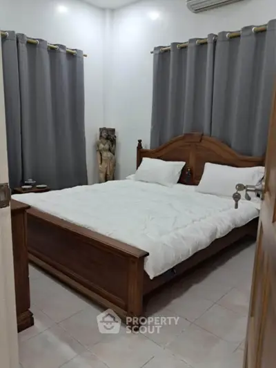 Cozy bedroom with wooden bed frame and elegant gray curtains
