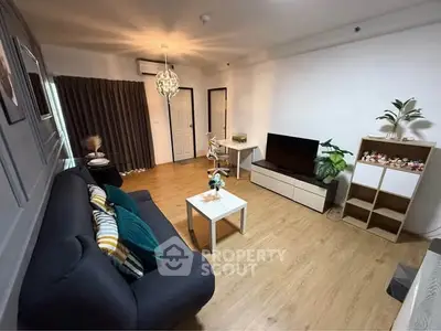 Modern living room with cozy sofa, stylish decor, and wooden flooring