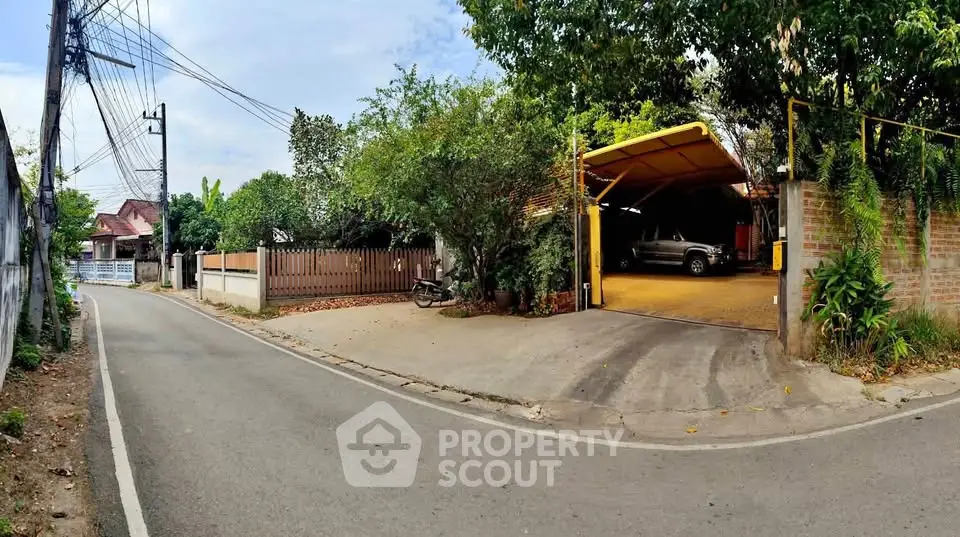 Charming suburban home with spacious driveway and lush greenery, perfect for family living.