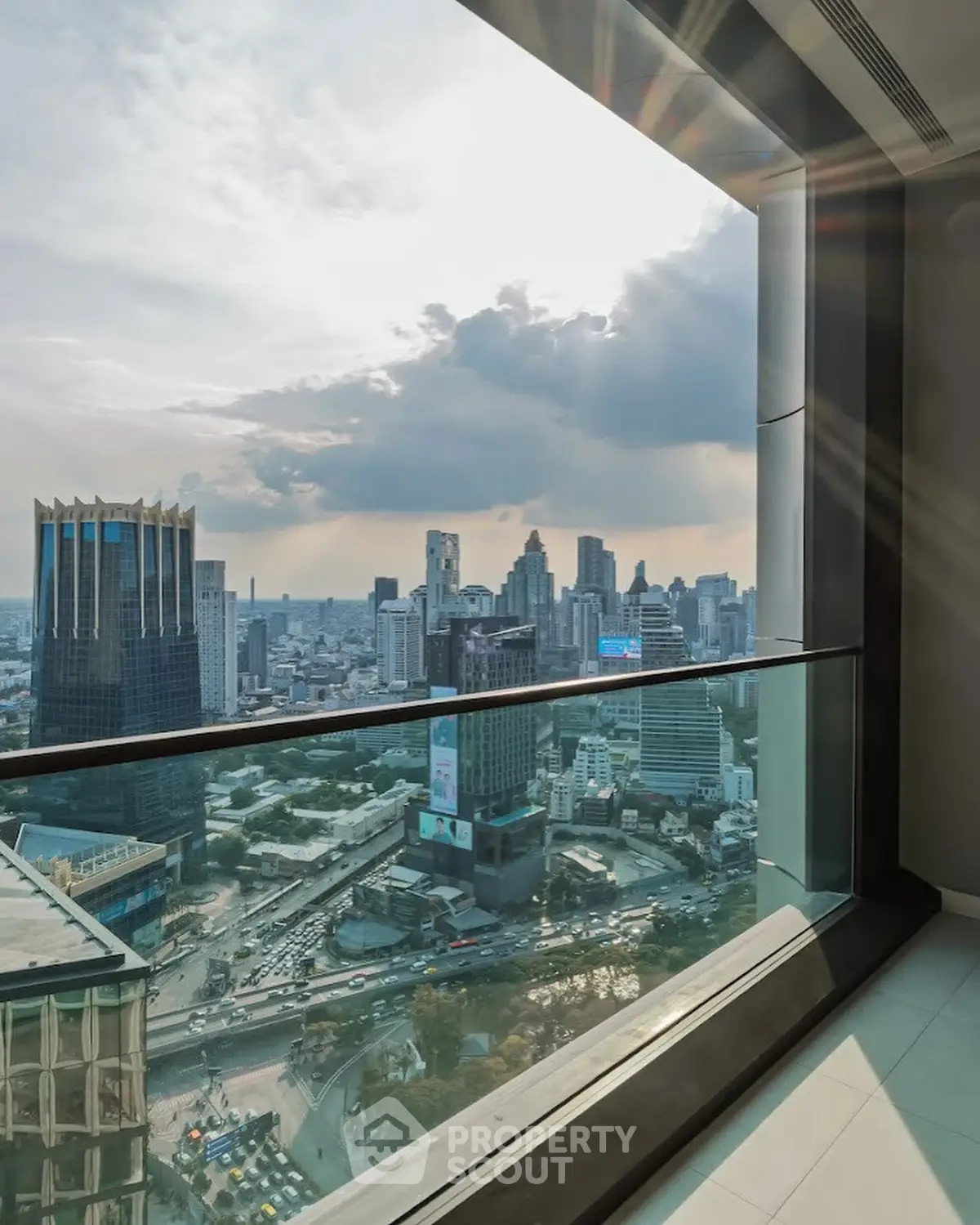Stunning cityscape view from high-rise apartment window, showcasing urban skyline and vibrant city life.