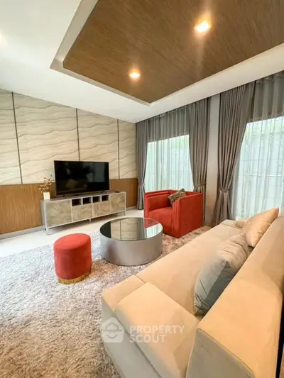Modern living room with stylish furniture and large windows for natural light.