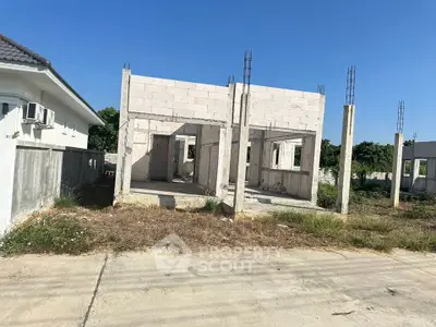 Unfinished residential building construction under clear blue sky