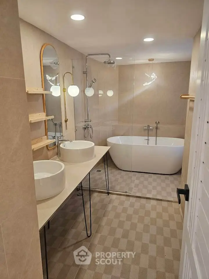 Luxurious bathroom with modern fixtures and elegant freestanding bathtub.