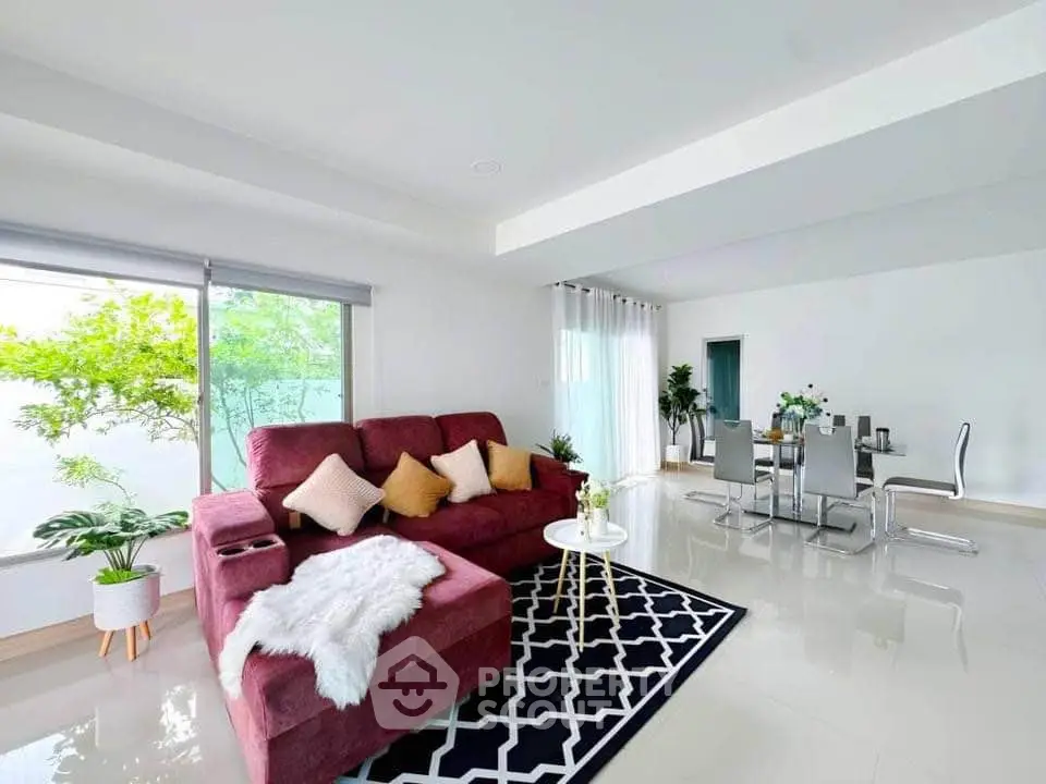 Spacious modern living room with elegant dining area and large windows