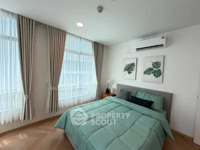 Bright and airy bedroom with modern decor and large windows in a stylish apartment.