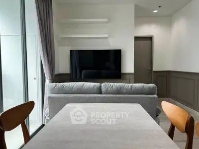 Modern living room with sleek TV setup and stylish furniture, perfect for contemporary living.