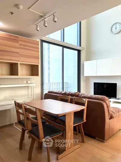 Modern living room with stylish furniture and large windows in a contemporary apartment.