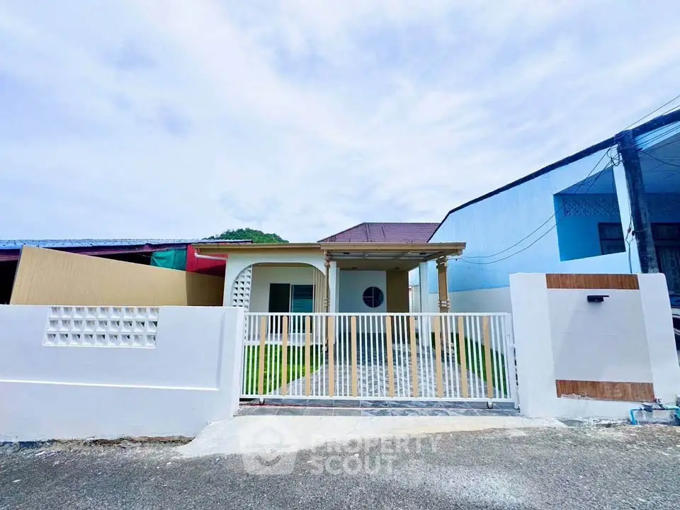 Charming single-story home with gated entrance and spacious driveway, perfect for family living.
