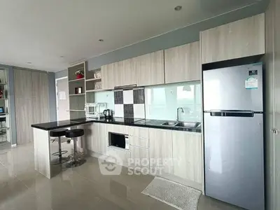 Modern kitchen with sleek cabinetry, built-in oven, and breakfast bar in a stylish apartment.
