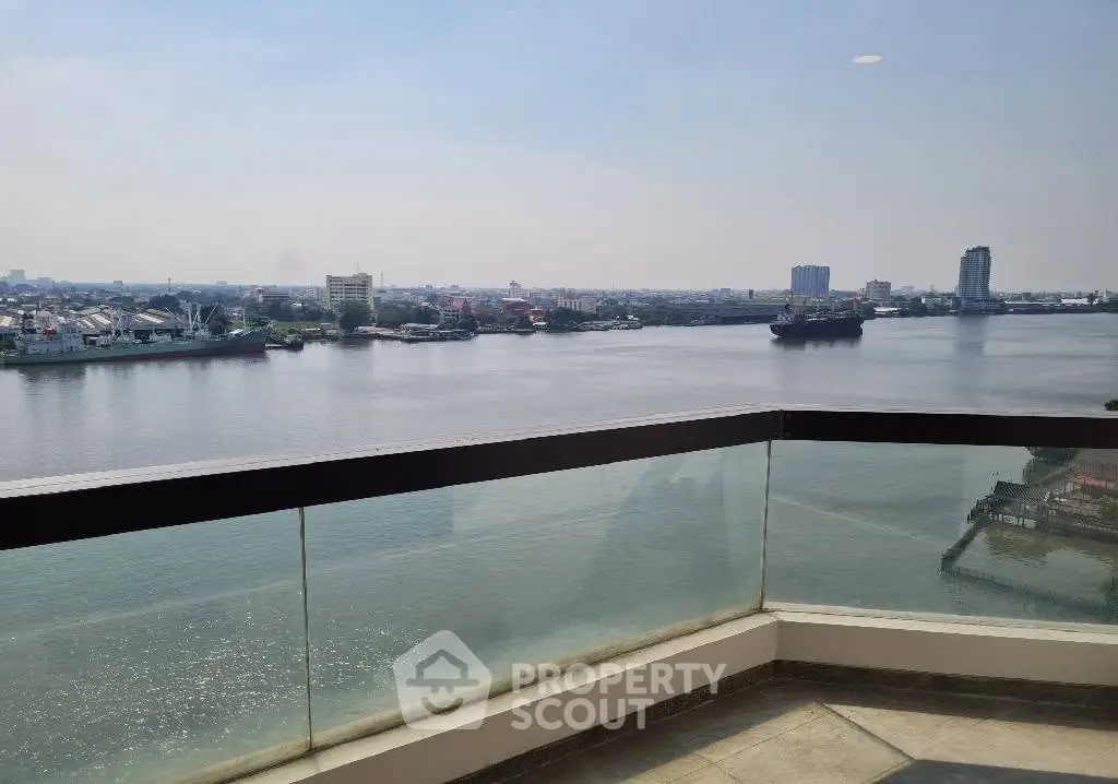Stunning river view from a modern balcony in a high-rise apartment, perfect for relaxation and enjoying the cityscape.