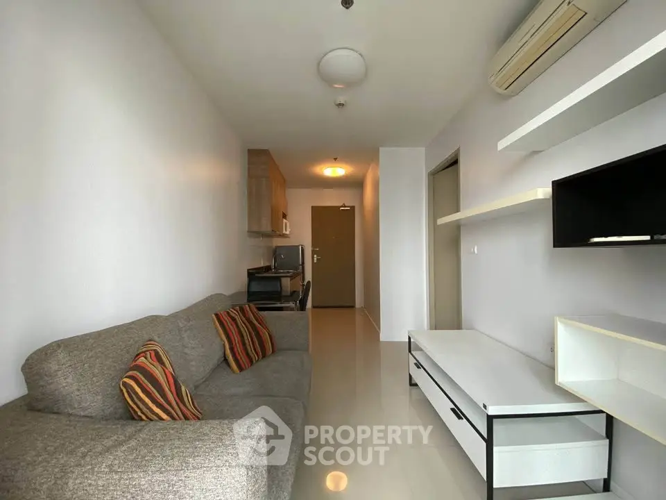 Modern living room with sleek furniture and open kitchen layout