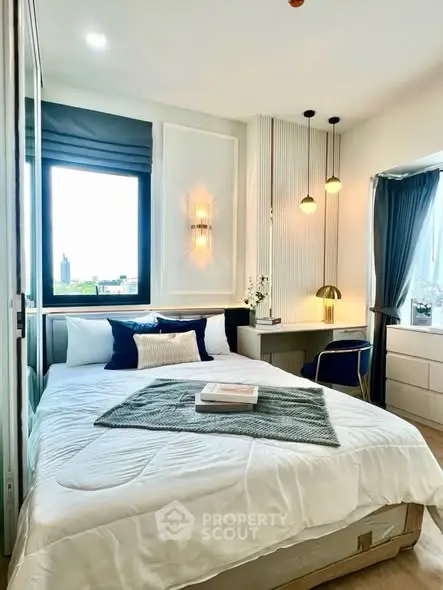 Modern bedroom with stylish decor and large window offering city view