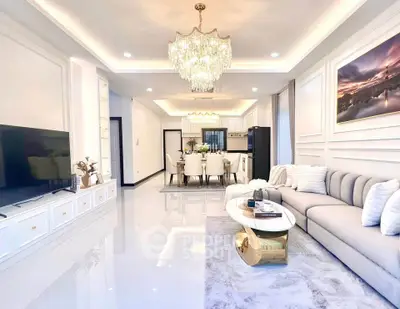 Luxurious open-concept living room with elegant chandelier and modern decor