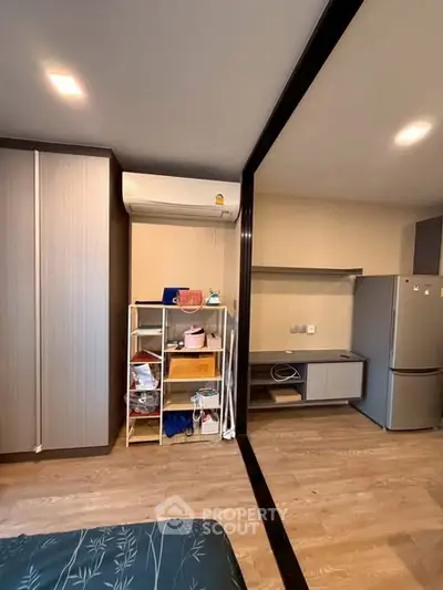 Modern apartment interior with air conditioning and sleek kitchen appliances.