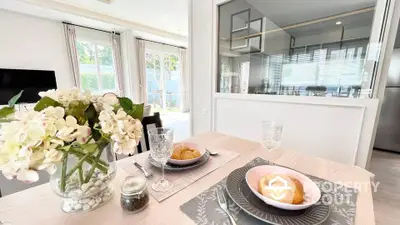 Elegant dining area with natural light and modern decor, perfect for cozy meals.