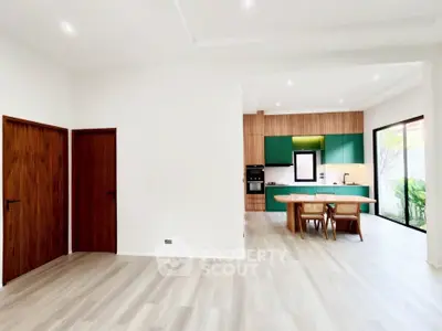 Spacious modern kitchen with open layout and stylish green cabinetry