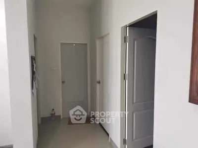 Minimalist hallway with white doors and clean lines