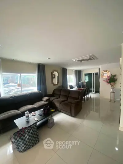 Spacious living room with modern furniture and large windows for natural light.