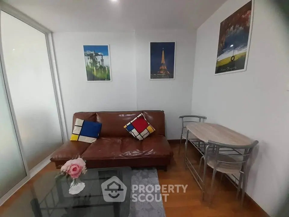 Charming living room with modern decor and cozy seating in a stylish apartment.