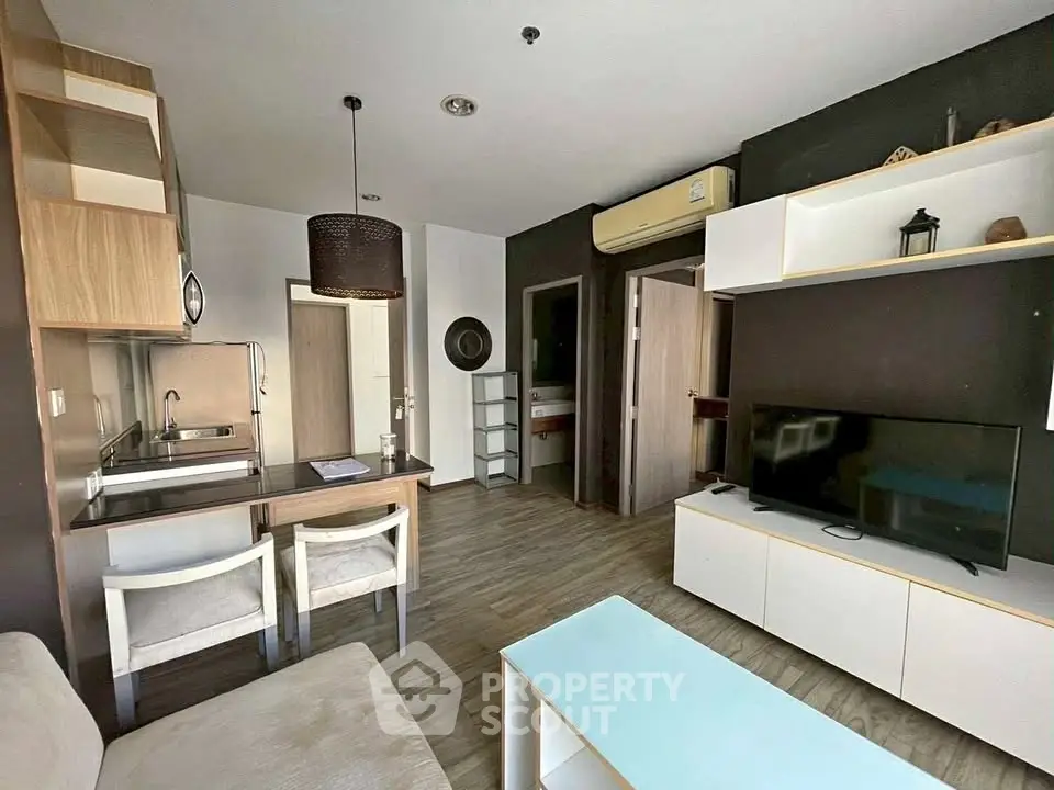 Modern living room with stylish furniture and open kitchen layout