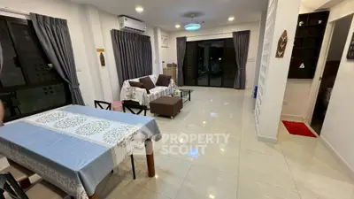 Spacious living room with modern decor and large windows for natural light.