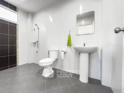 Spacious modern bathroom with sleek fixtures and elegant tile design.
