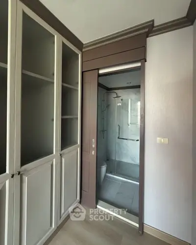 Modern compact bathroom with sliding door and built-in storage