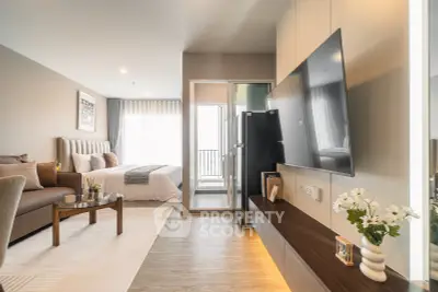 Modern studio apartment with open layout, featuring a cozy living area and stylish bedroom.