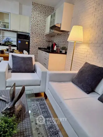 Modern living room with stylish decor and open kitchen layout, featuring cozy seating and elegant lighting.
