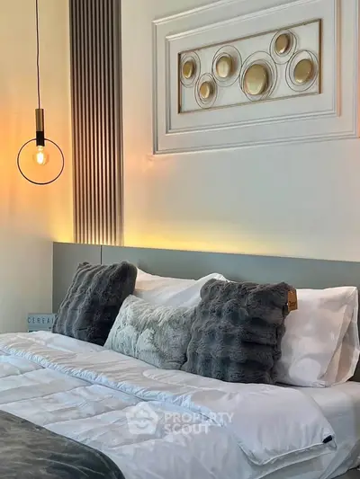 Luxurious bedroom with modern decor and plush pillows, perfect for relaxation and comfort.