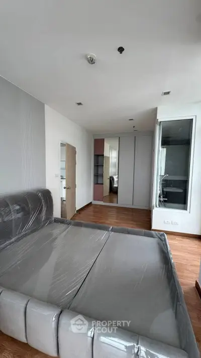 Spacious bedroom with modern design and large bed in a stylish apartment.