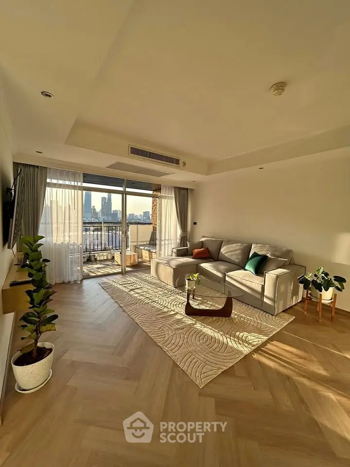 Spacious living room with modern decor and city view balcony in luxury apartment.