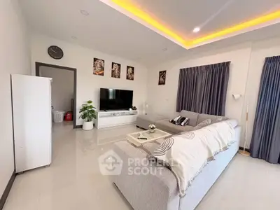 Modern living room with sleek design, cozy gray sofa, and stylish decor, perfect for relaxation and entertainment.