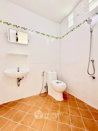Spacious bathroom with modern fixtures and tiled flooring, perfect for comfort and style.