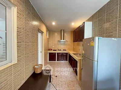Modern kitchen with sleek cabinetry and stainless steel appliances in a stylish home.
