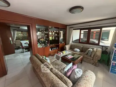 Spacious living room with elegant wooden cabinetry and cozy seating area.