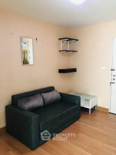 Cozy living room with modern sofa and wall shelves in a stylish apartment.