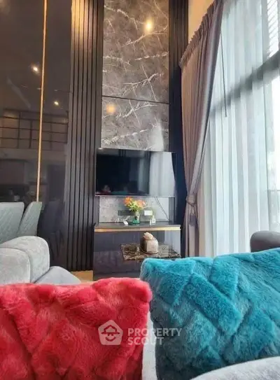 Luxurious living room with modern decor and large windows for natural light.