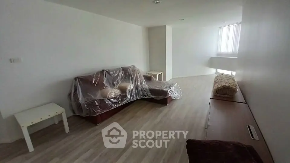 Spacious living room with modern flooring and natural light